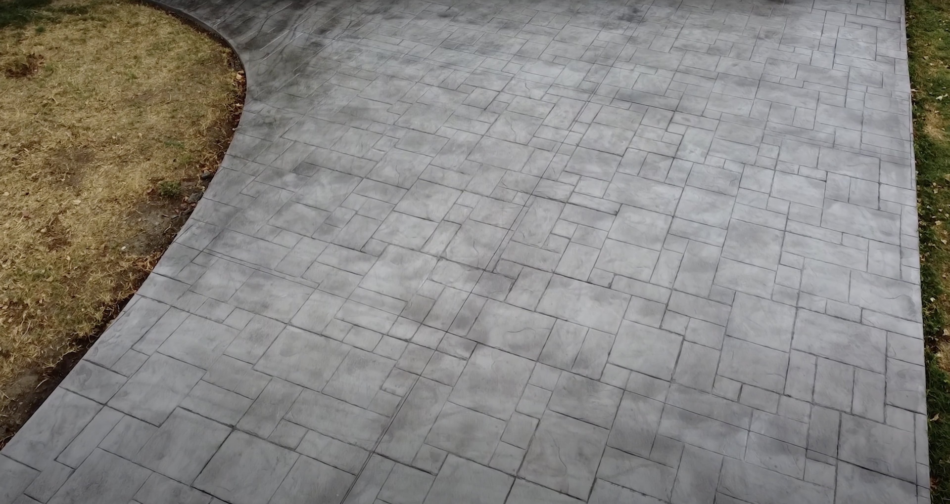 Stamped concrete patio with brick pattern design showing decorative concrete installation