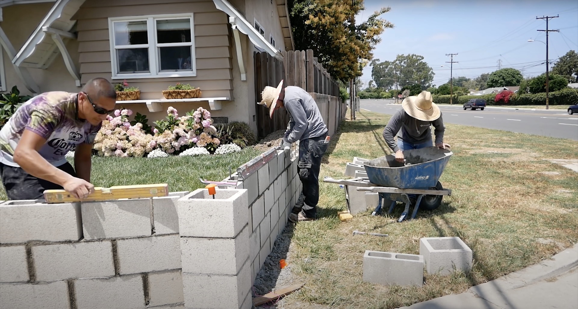 Concrete construction crew working on residential retaining wall project