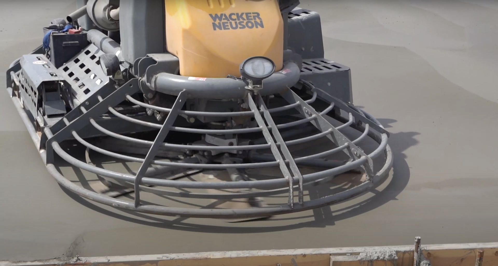 Professional concrete finishing equipment including power trowel for smooth concrete surfaces
