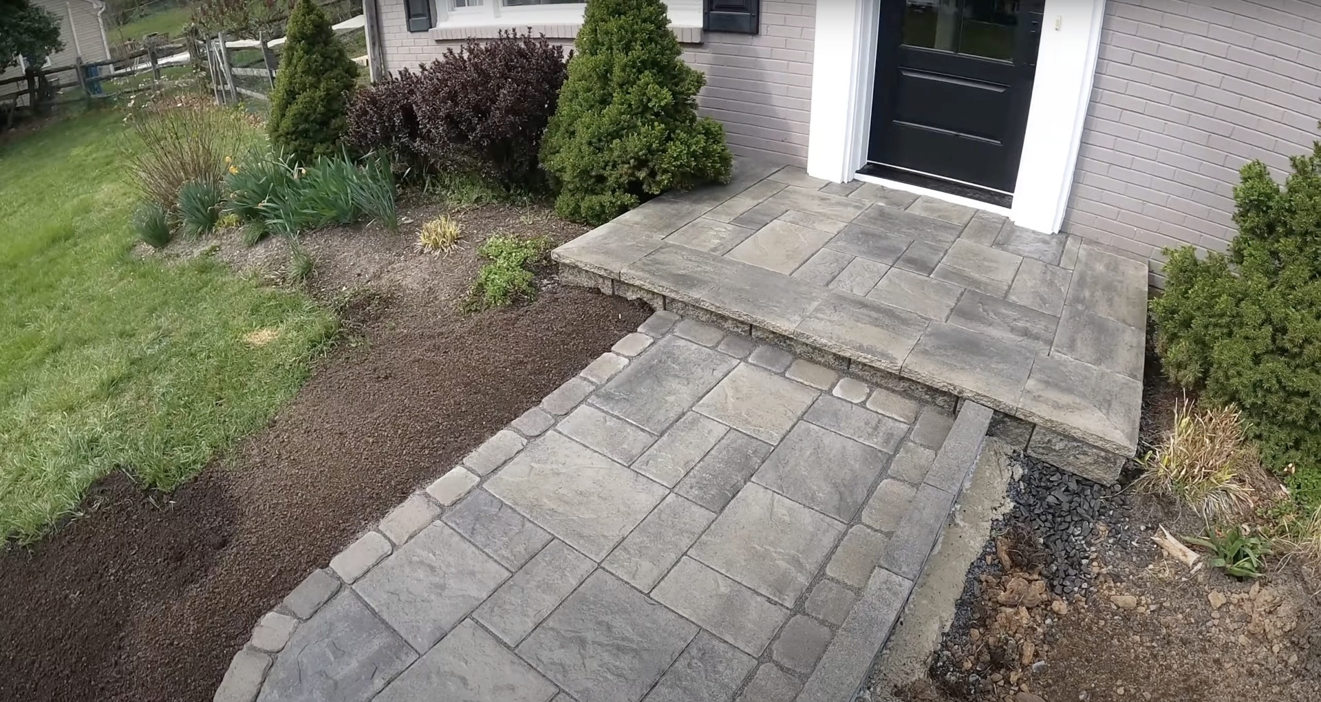 Elegant concrete patio and walkway installation with professional landscaping integration