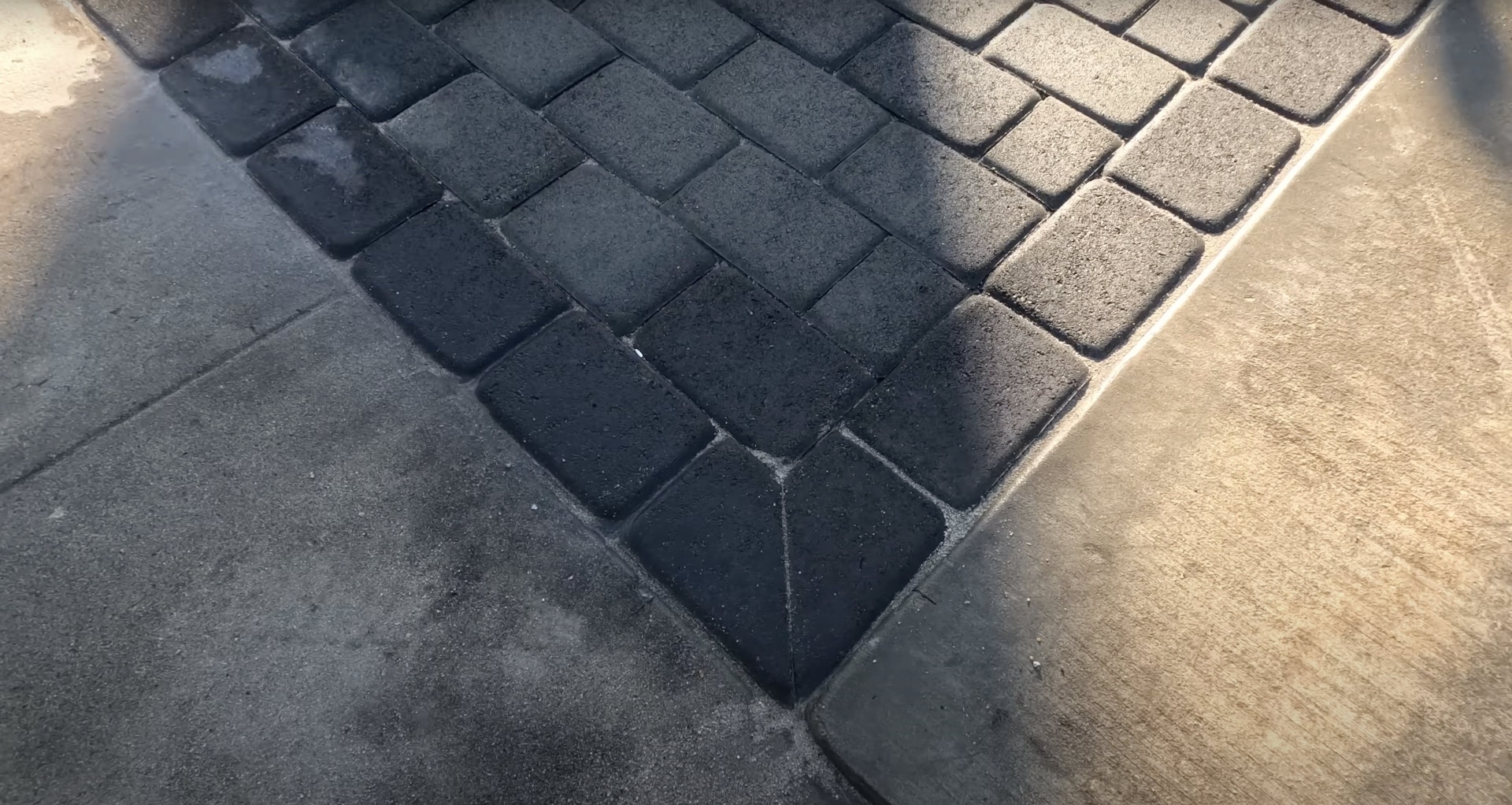 Interlocking concrete paver installation showing precision concrete work