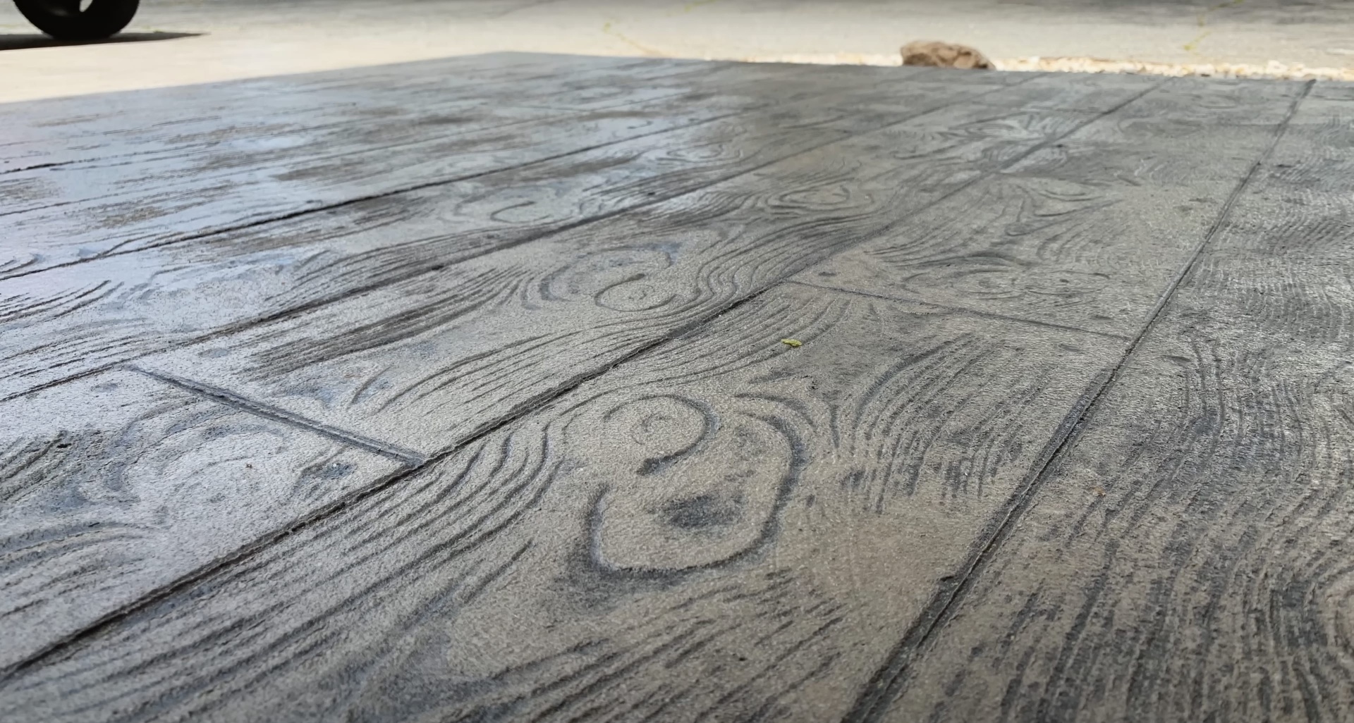 Wood-grain stamped concrete showing decorative concrete finishing techniques